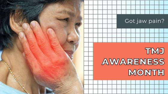 Older woman clutches jaw with hand